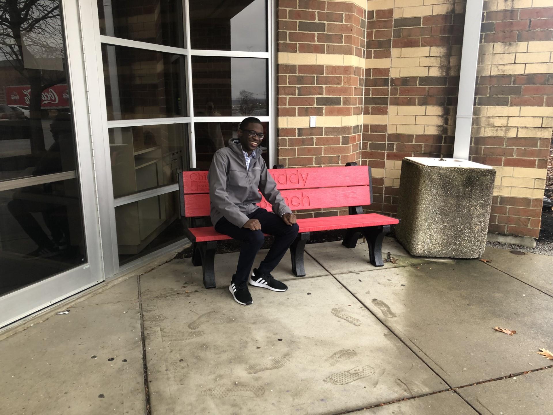 Devin Duncan sitting on the Buddy Bench